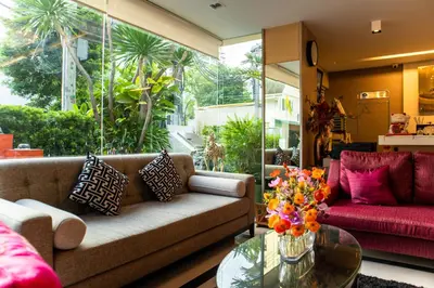 a living room with a couch and a glass table at Shine Sukhumvit 33 Aparthotel Phrompong in Bangkok
