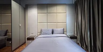 a bedroom with a large bed with a large headboard at Brown Brick Thonglor - Green Greenery Room in Bangkok