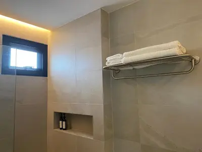 a bathroom with a shower with towels on a wall at THE CELESTRAIL - Apartment - Check-In by Appointment Only - Non-hotel - Onnut BTS in Bangkok