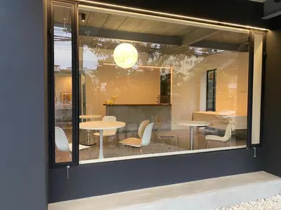 a window of a restaurant with tables and chairs at THE CELESTRAIL - Apartment - Check-In by Appointment Only - Non-hotel - Onnut BTS in Bangkok