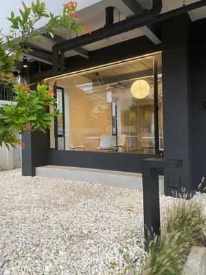 a house with a large window on the side of it at THE CELESTRAIL - Apartment - Check-In by Appointment Only - Non-hotel - Onnut BTS in Bangkok