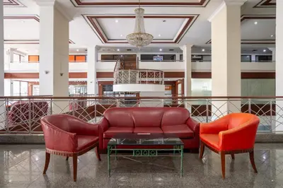 a lobby with a couch and two chairs at Artichoke Suite Sukhumvit, Nana BTS in Bangkok