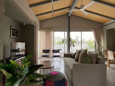 a living room with a couch and a ceiling fan at Private apartment at Sukhumvit67 Penthouse Unit in Bangkok