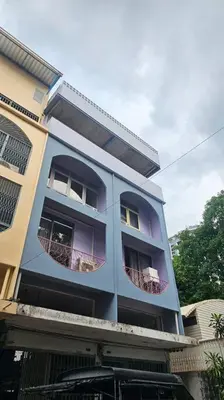 a blue building with two balconies on it at Private apartment at Sukhumvit67 Penthouse Unit in Bangkok