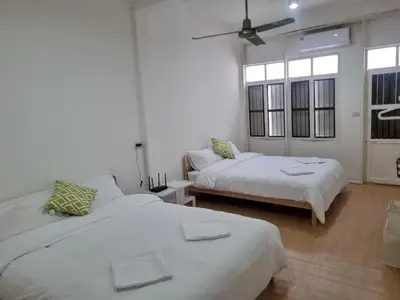 a bedroom with two beds and a ceiling fan at Haus Sathorn Pier 2 Cozy Bedroom City Center in Bangkok