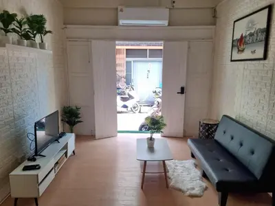a living room with a couch and a tv at Haus Sathorn Pier 2 Cozy Bedroom City Center in Bangkok