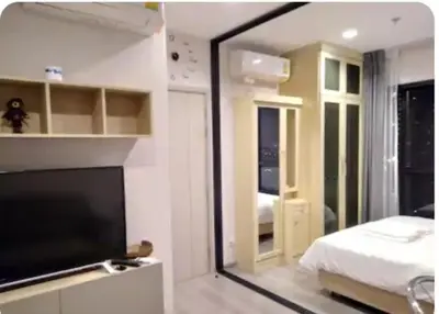a bedroom with a mirror and a bed and a television at Sky & River side view bts condo in Ban Sai Ma
