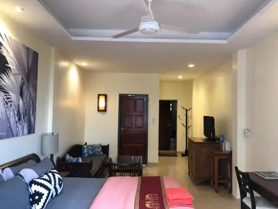 a bedroom with a bed and a ceiling fan at Blue Chang House in Bangkok