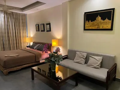 a living room with a bed and a couch at Blue Chang House in Bangkok