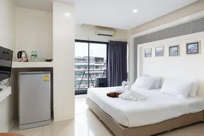 a bedroom with a large white bed and a window at Baron Zotel Bangkok SHA PLUS in Bangkok