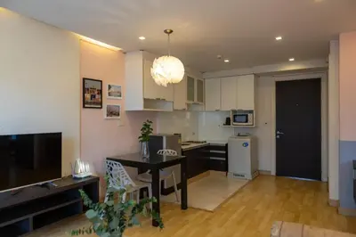 a kitchen with a table and a dining room at P Villa Lamoon Thonglor in Bangkok