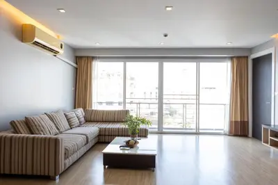 a living room with a couch and a large window at P Villa Lamoon Thonglor in Bangkok