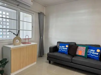 a living room with a black couch and a window at MIQ HK256 5BR MRT Ratchada and HuaiKhwang in Bangkok