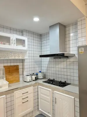 a kitchen with white appliances and white tile walls at MIQ HK256 5BR MRT Ratchada and HuaiKhwang in Bangkok