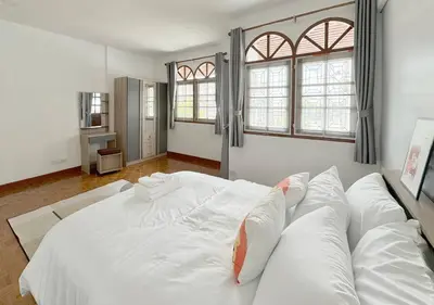 a large white bed in a room with windows at MIQ HK611 Huai Khwang 4BR Jodd fair in Bangkok