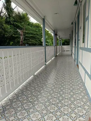 an empty corridor with a tile floor on a building at Baan Debtida in Bangkok