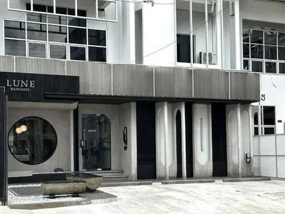 a building with a bench in front of it at Lune bangkok in Bangna
