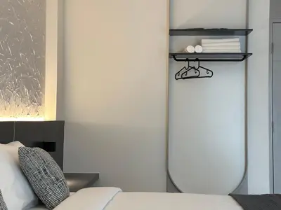 a living room with a surfboard on a wall at Lune bangkok in Bangna