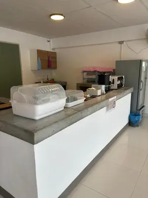 a kitchen with a counter top with a appliance at Ther Bangkoknoi Hotel in Bangkok Noi
