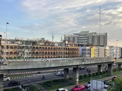 a city with a bridge and cars on a highway at Ther Bangkoknoi Hotel in Bangkok Noi