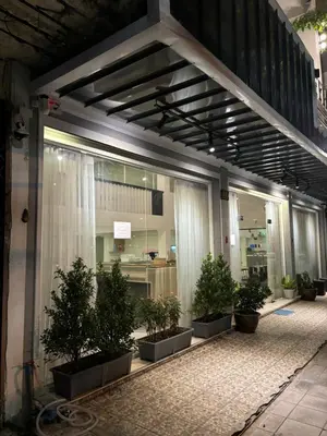 a group of potted trees sitting outside of a building at Ther Bangkoknoi Hotel in Bangkok Noi