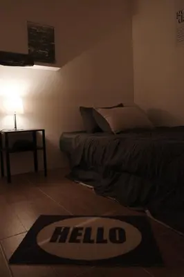 a bed room with a hello rug on the floor at Round The Clock Hostel in Samphanthawong