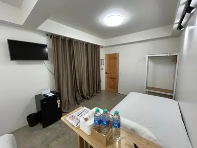 a hospital room with a bed and a table with water bottles at Choose me guesthouse in Bang Kruai