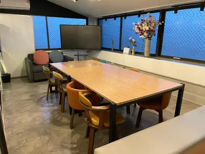a conference room with a table and chairs at Choose me guesthouse in Bang Kruai