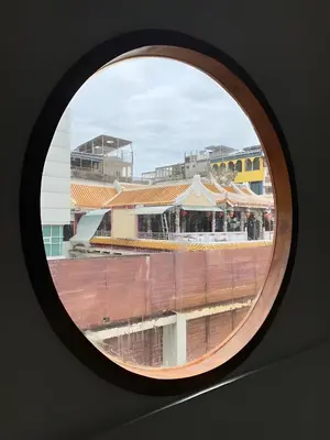 a round window with a view of a building at XX Hidden Dragon ChinaTown MRT Wat Mangkon Station in Samphanthawong