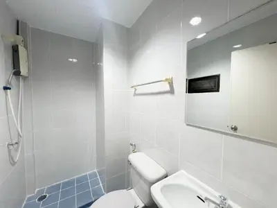 a bathroom with a toilet and a sink and a mirror at Vonden Garden by Merry V in Bangkok