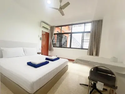 a bedroom with a bed with blue towels on it at Vonden Garden by Merry V in Bangkok