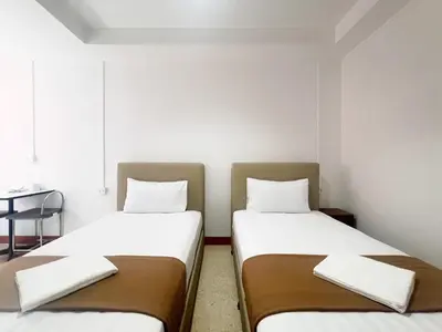 two beds sitting next to each other in a room at Vonden Garden by Merry V in Bangkok