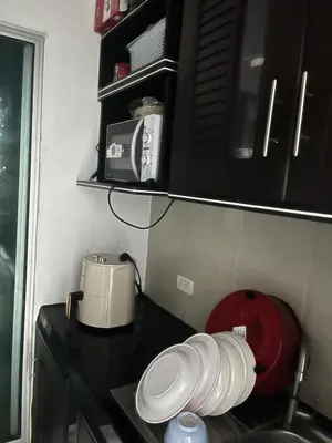 a kitchen with a counter with a toaster and a microwave at Love Nest in Bangkok