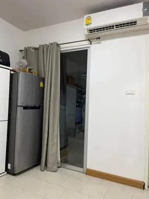 a kitchen with a refrigerator and a sliding glass door at Love Nest in Bangkok