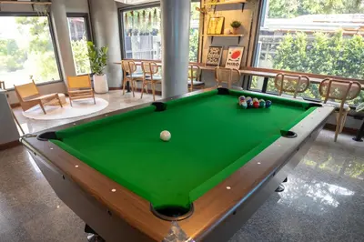 a pool table in a living room with afits at DMK Place in Bangkok