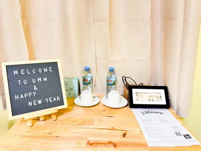 a table with a new year sign and a tablet at ฐิติพร อพาร์ทเมนต์ บางเขน in Tha Akatsayan Don Muang