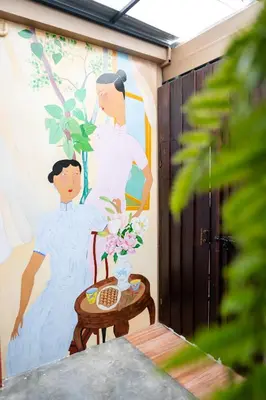 a painting of a bride and groom on a wall at BB Boutique Sathorn in Bangkok
