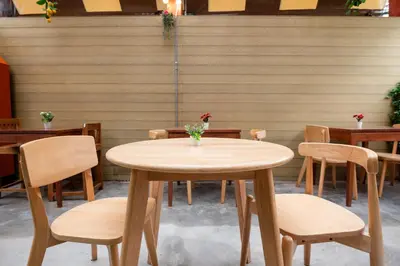 a wooden table and chairs in a restaurant at BB Boutique Sathorn in Bangkok