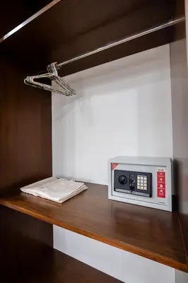 a microwave sitting on top of a wooden shelf at BB Boutique Sathorn in Bangkok