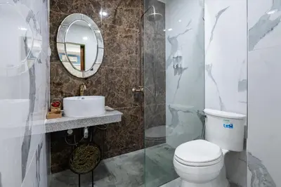 a bathroom with a toilet and a mirror at BB Boutique Sathorn in Bangkok