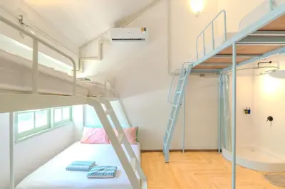 a small bedroom with a bunk bed and a ladder at The Green Khaosan Bangkok in Bangkok