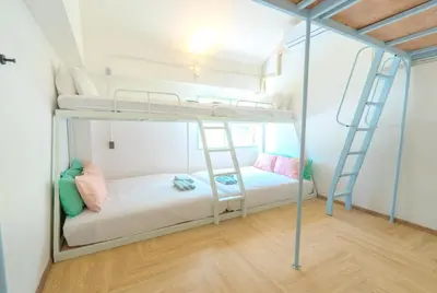 a bunk bed room with two bunk beds and a ladder at The Green Khaosan Bangkok in Bangkok