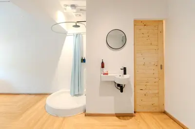 a bathroom with a sink and a mirror at The Green Khaosan Bangkok in Bangkok