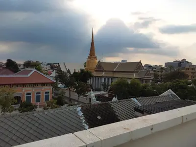a view of a city with a pagoda in the background at Kanyakorn House Near Khao San in Bangkok
