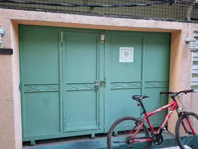 a bike parked in front of a green door at Kanyakorn House Near Khao San in Bangkok