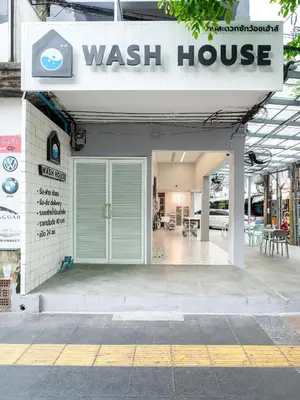 a wash house with a sign on top of it at Wash House Chatuchak in Bangkok