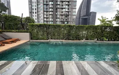 a swimming pool in a city with tall buildings at Luxury condo right next to BTS Thonglor! in Bangkok