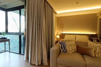 a living room with a couch and a large window at Luxury condo right next to BTS Thonglor! in Bangkok