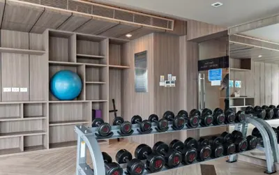 a gym with a row of dumbbells on the wall at Luxury condo right next to BTS Thonglor! in Bangkok