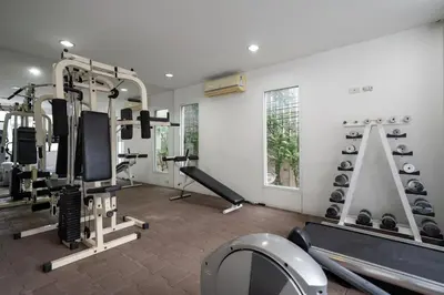 a gym with several tread machines in a room at Story At Bangkok- 211 Studio with Balcony in Khlong Toei